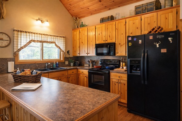 Fully stocked kitchen with modern appliances, coffee maker & everything you need for family meals.