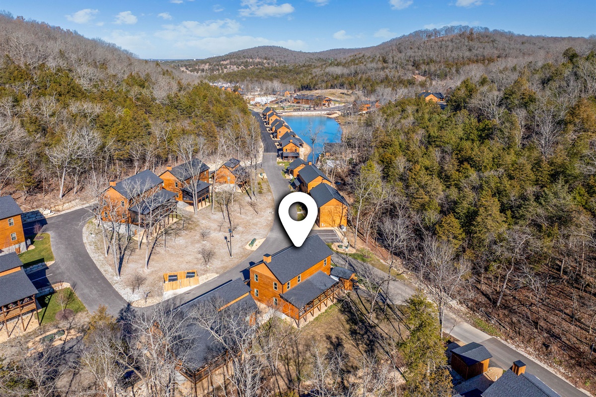 Aerial view of the cabin community, showing the peaceful wooded surroundings with hiking trails and a fishing lake just steps away.