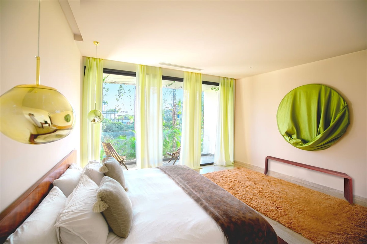 Large bedroom with king sized bed and private balcony, closets and bathroom ensuite. 