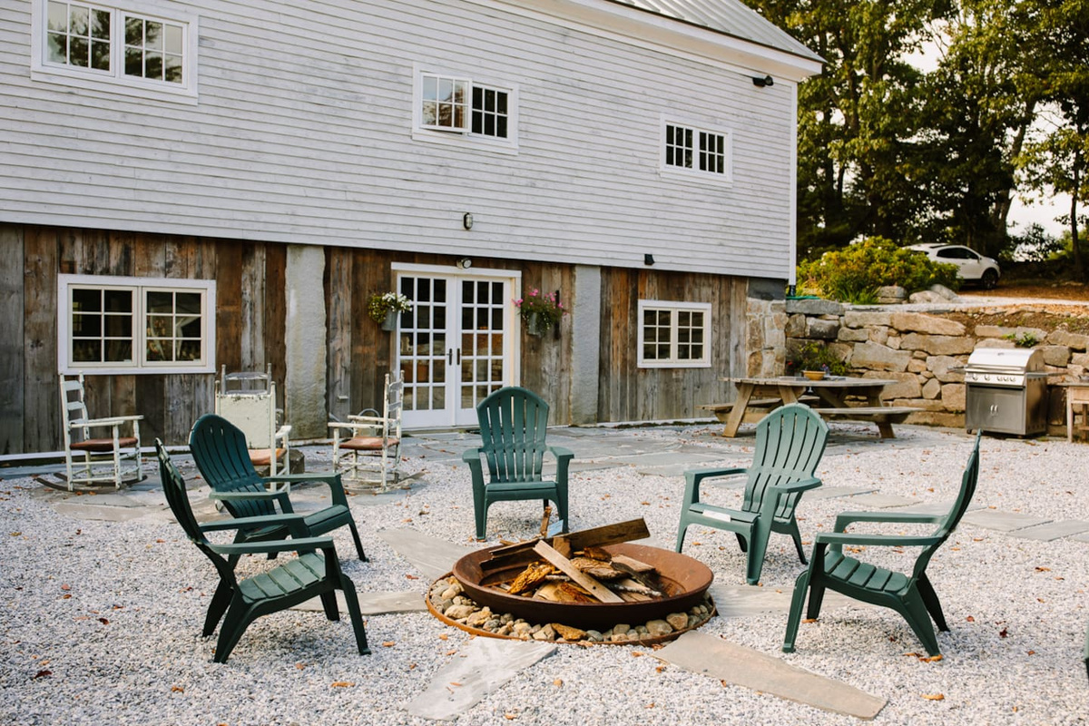 Private outdoor stone terrace with fire pit, gas grill and picnic table.