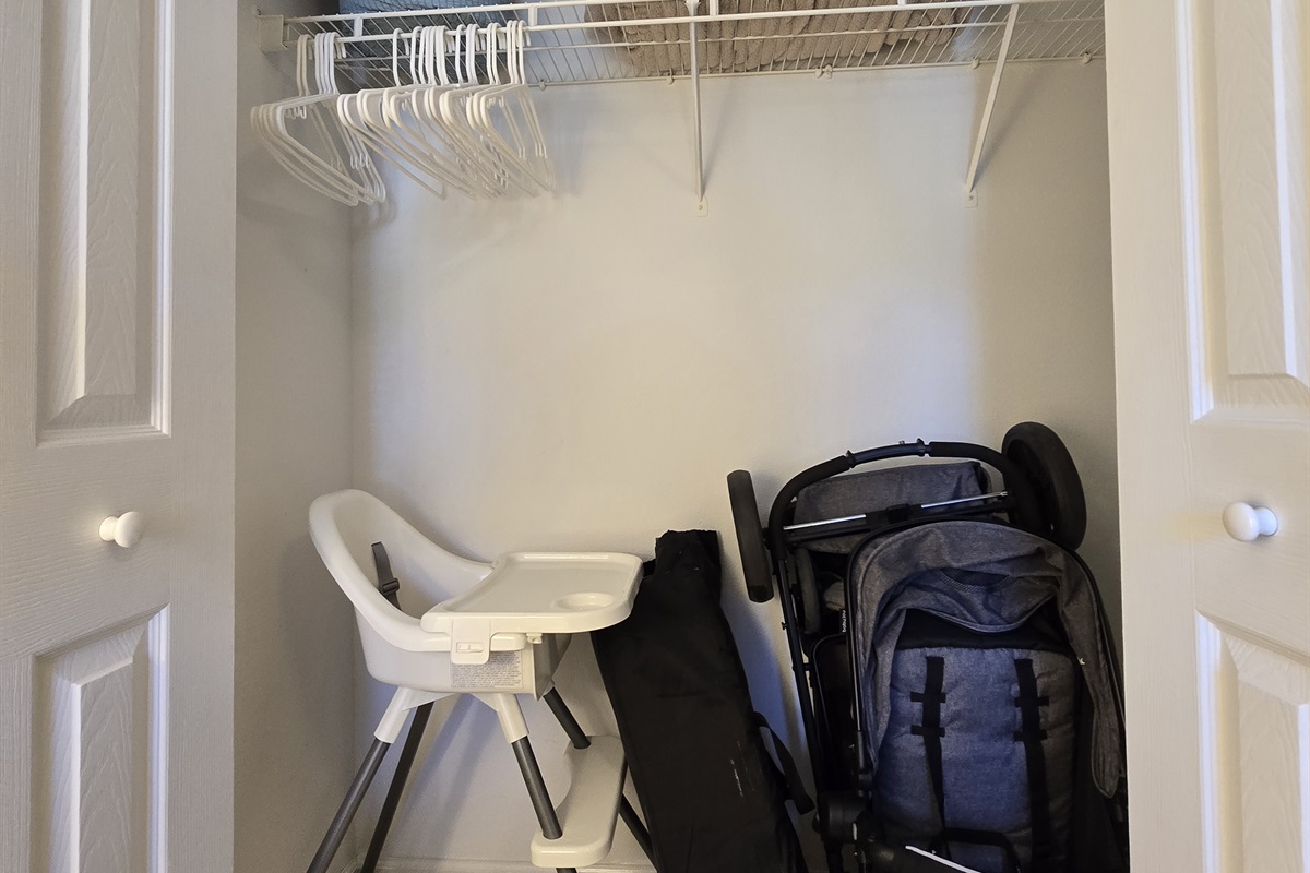 2nd Bedroom Closet with Stroller, High Chair, and Pack n Play for Guest Use