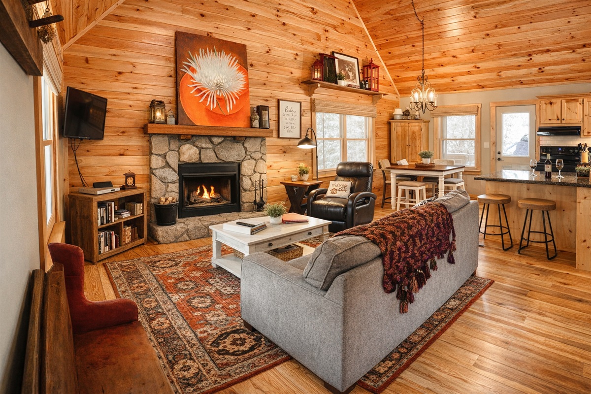 Cozy up by the stone fireplace in this warm, open-concept mountain cabin—where rustic charm, plush seating, and a fully stocked kitchen create the perfect space to relax after a day exploring Helen.