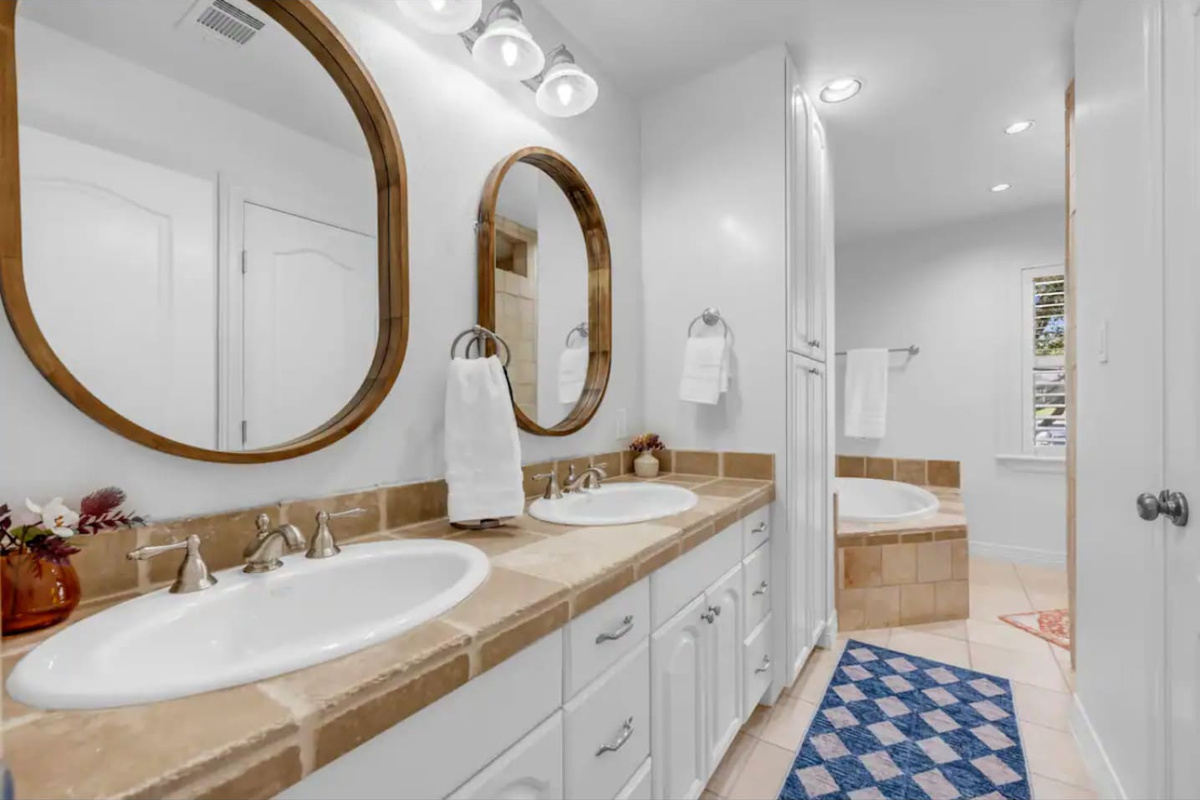 Upstairs primary bathroom with tub and shower