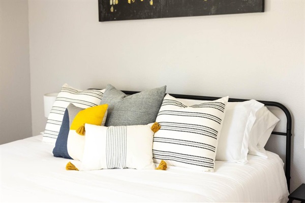 The relaxing king bed setup includes soft linens and decorative touches, ensuring a restful night’s sleep.