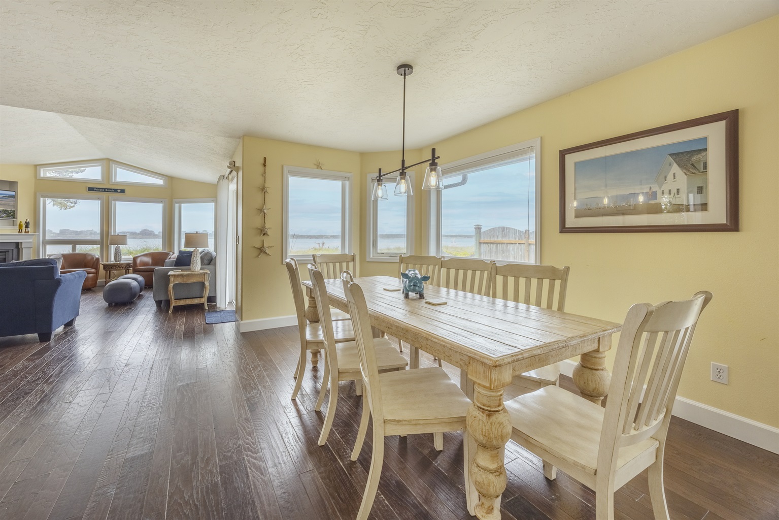 Open living, kitchen, and dining area surrounded by stunning views.