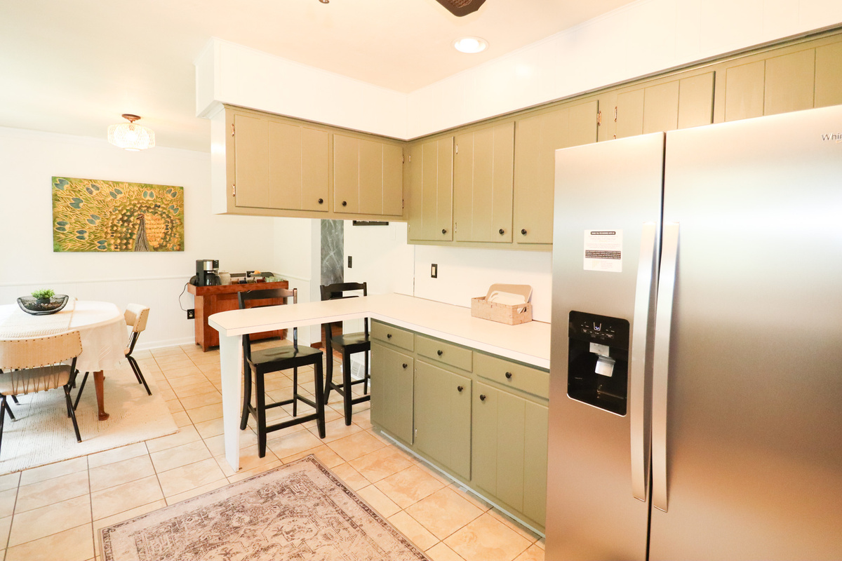 The heart of the home—a fully updated kitchen with all-new appliances, counter seating, and an open flow into the dining area that's perfect for gathering with family and friends.