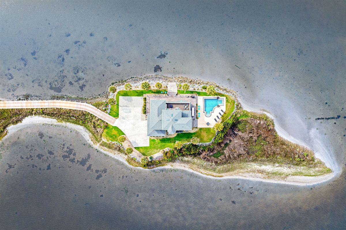 A truly one-of-a-kind private peninsula property surrounded by water on nearly every side