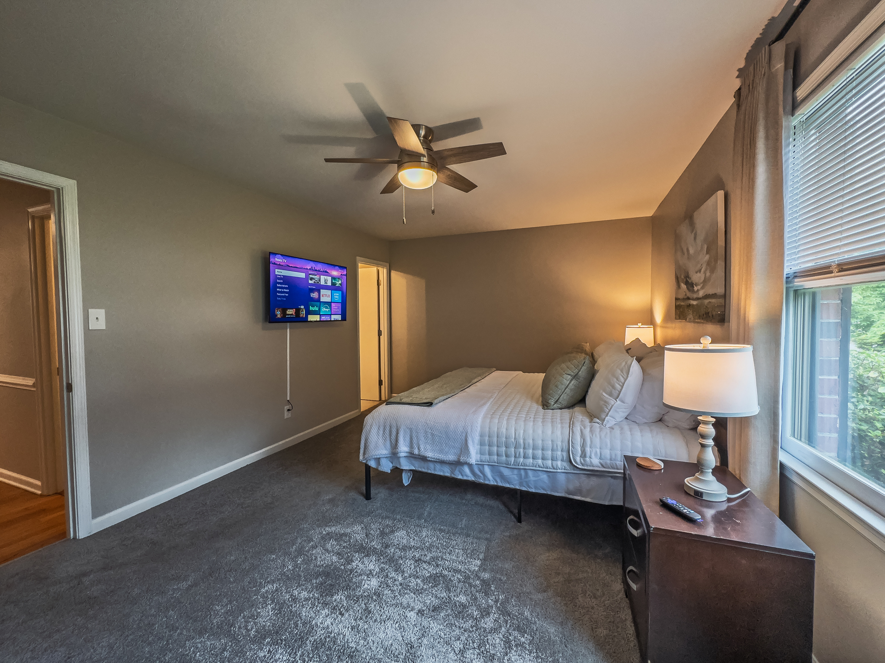 Primary Bedroom, King bed, 55" Smart TV, ceiling fan, two led light nightstands with multiple charging ports, two multi light function lamps, blackout curtains, dresser and closet, private full bathroom.