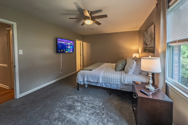 Primary Bedroom, King bed, 55" Smart TV, ceiling fan, two led light nightstands with multiple charging ports, two multi light function lamps, blackout curtains, dresser and closet, private full bathroom.