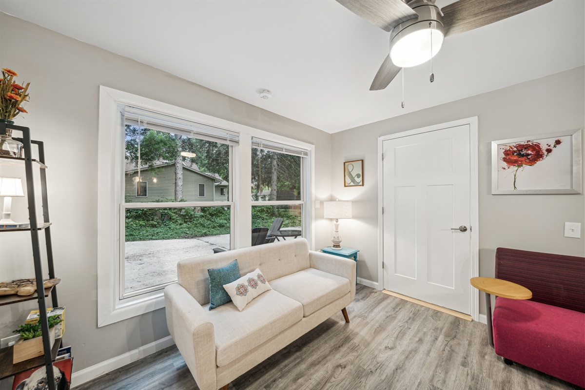 View of the common area of the lower apartment. Accessible bathroom door closed.