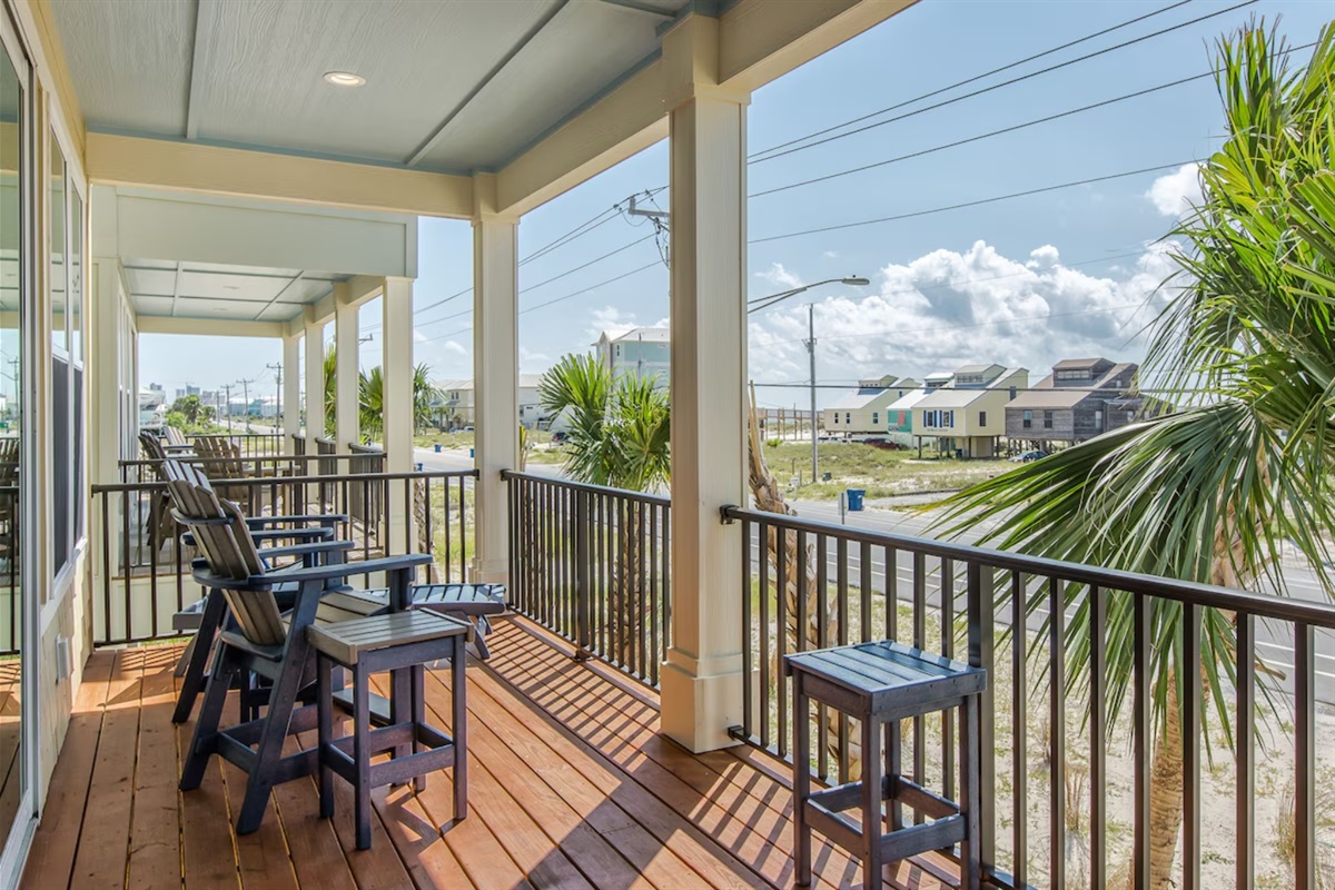 Beautiful covered front porch with Gulf views and plenty of seating 