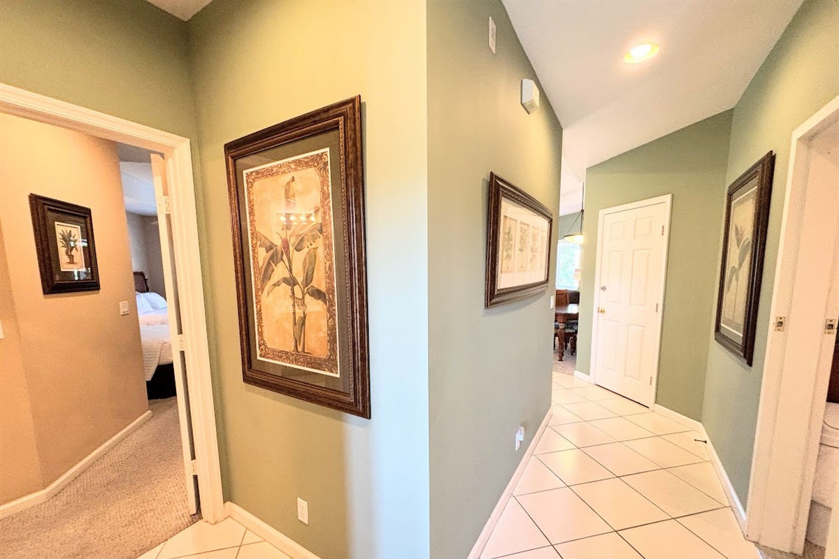 Entry hallway with tile flooring and neutral finishes, providing access to the main living areas and bedrooms.