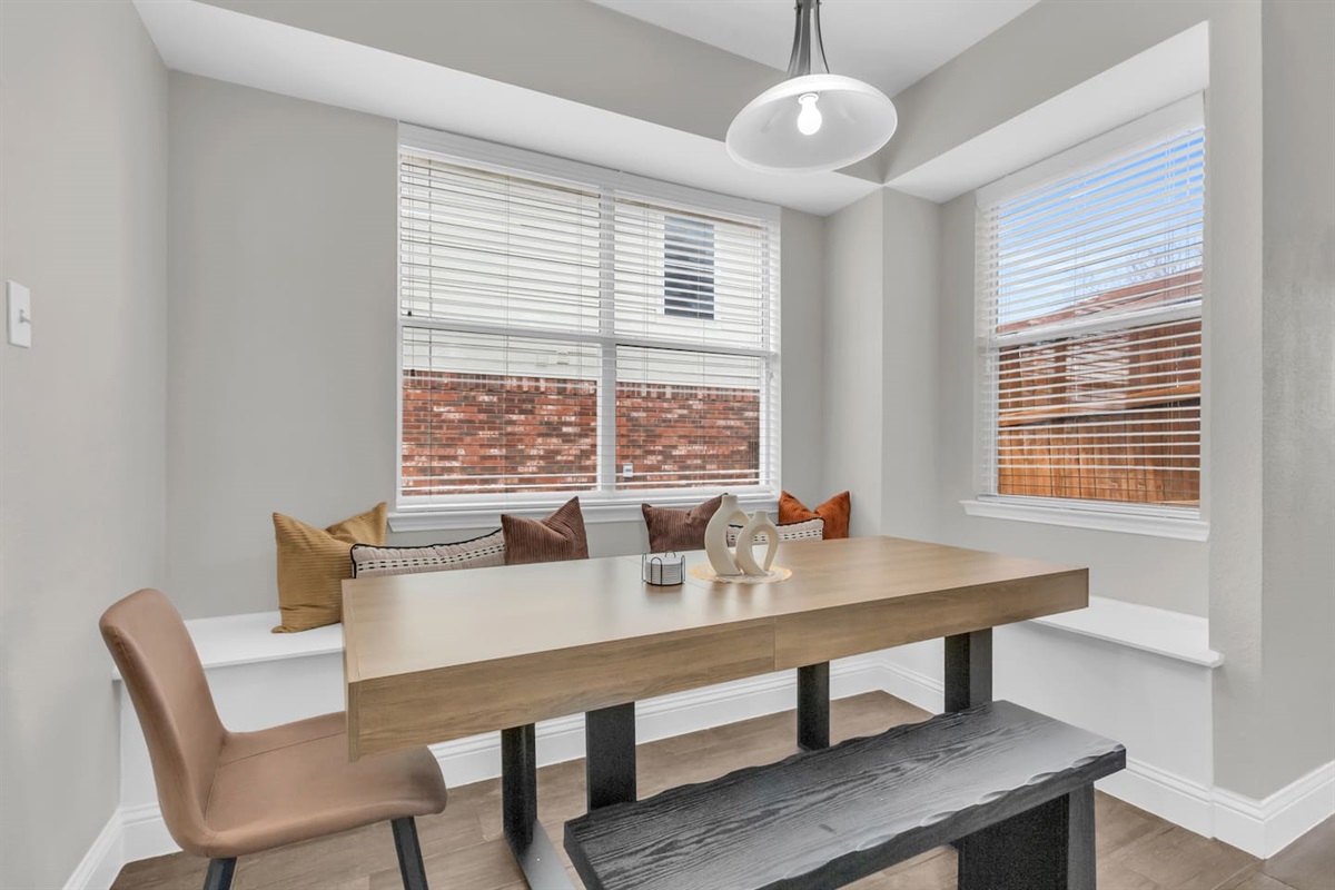 Kitchen-adjacent dining nook with seating for seven, designed for convenience and easy group living.