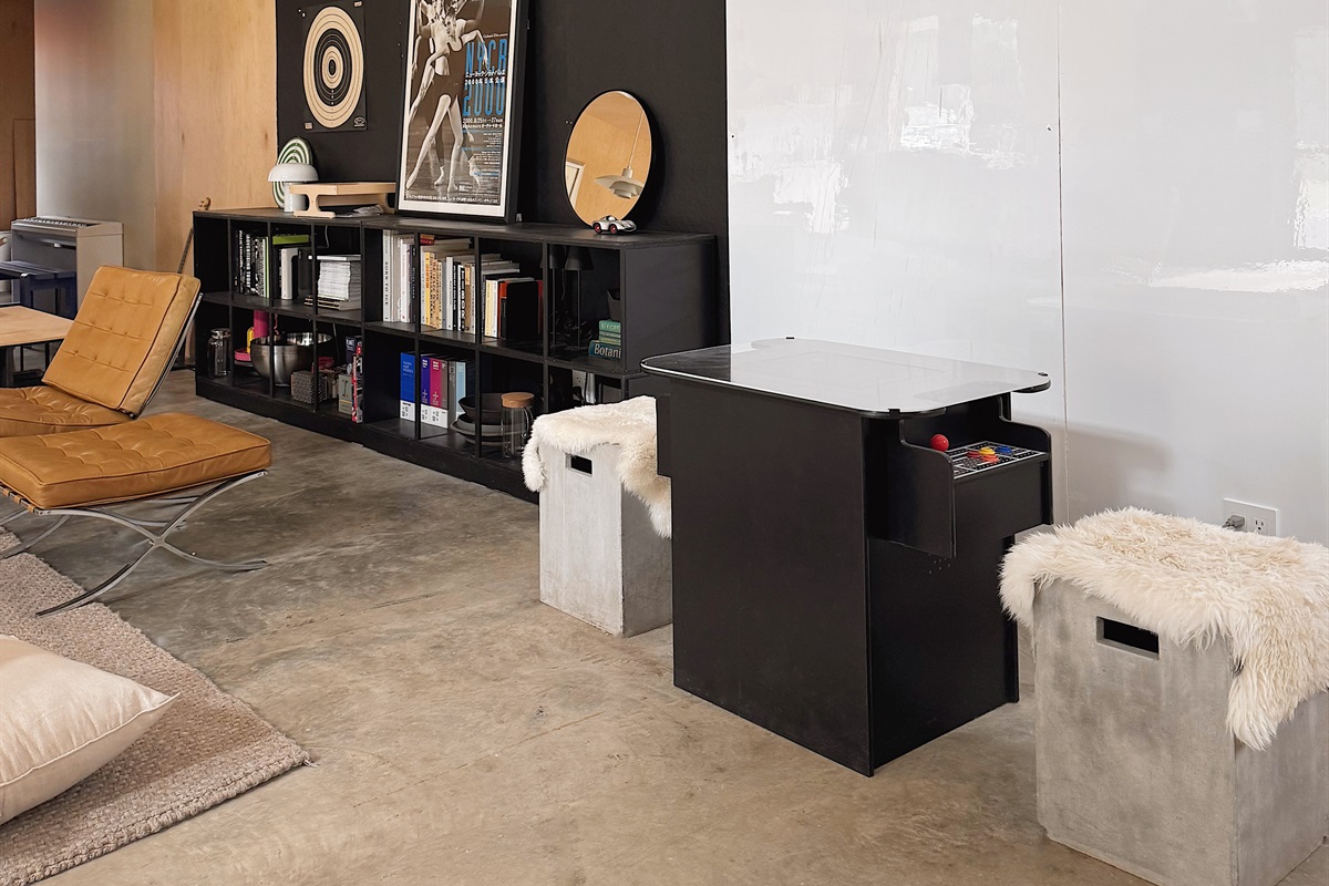 Arcade table with over 400 games, including Ms. Pacman and Frogger. 8x8 whiteboard wall behind.