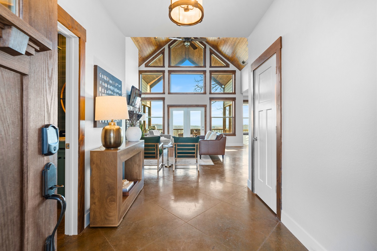 Step inside to a bright, welcoming entry that immediately draws your eye to the soaring windows and breathtaking views beyond.