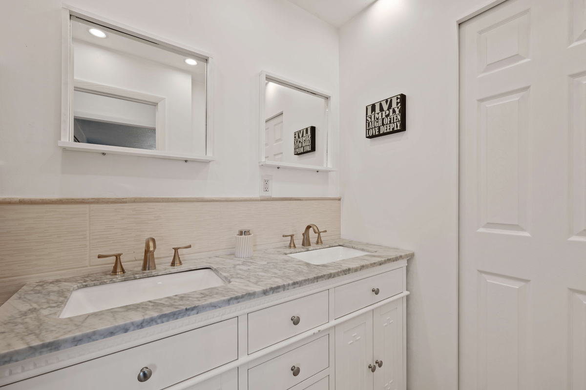 The door to the shower and toilet can be closed for privacy while still allowing access to the sinks.