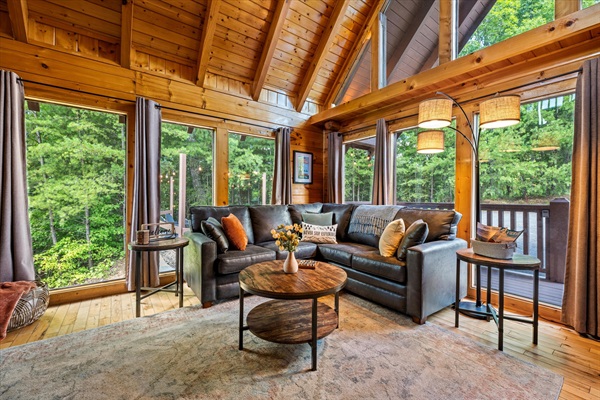 Tree-lined views and big windows make the living room the perfect spot to unwind..