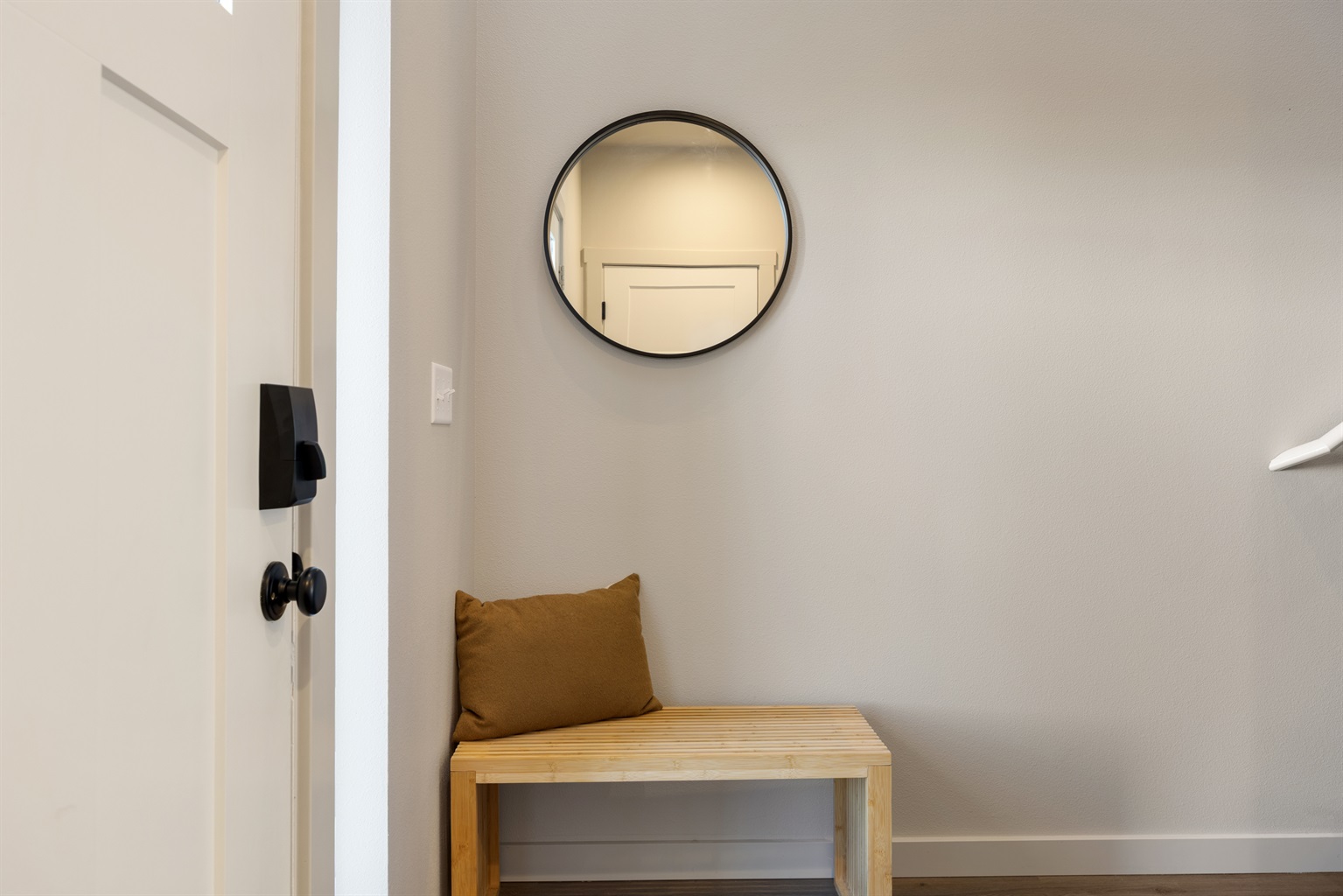 Entryway with mirror, bench, and coat hooks