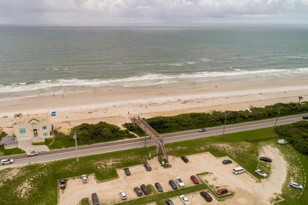 This is your beach access - a wooden walkover that lifts you across the coast road and sets you down on the sand. There is public parking at the base of it, though most days you will simply walk from the house.