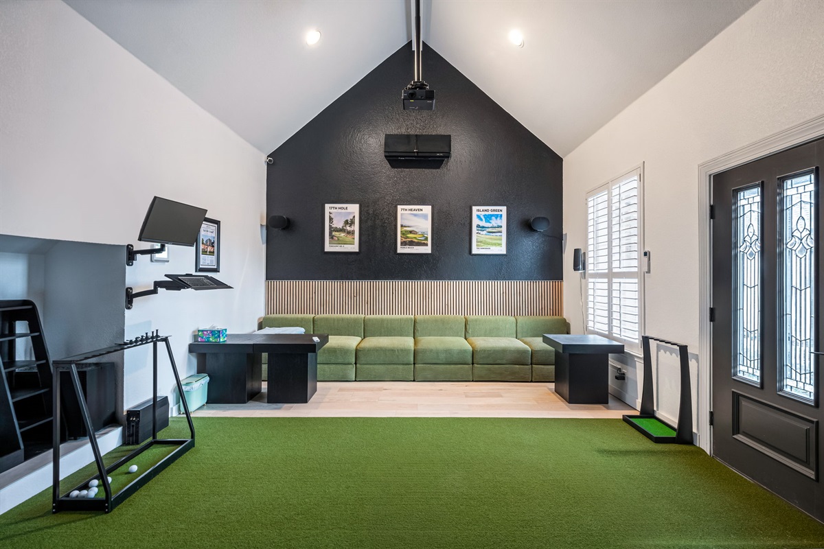 Indoor putting green and game space — enjoy year-round fun right inside the home.