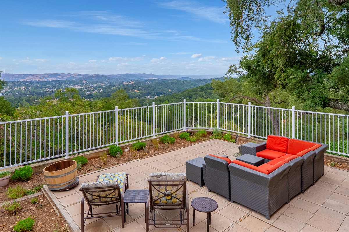 Relax on the plush sectional seating or sunny lounge chairs while taking in the spectacular, panoramic views of the rolling hills and distant landscape from this expansive, private patio.