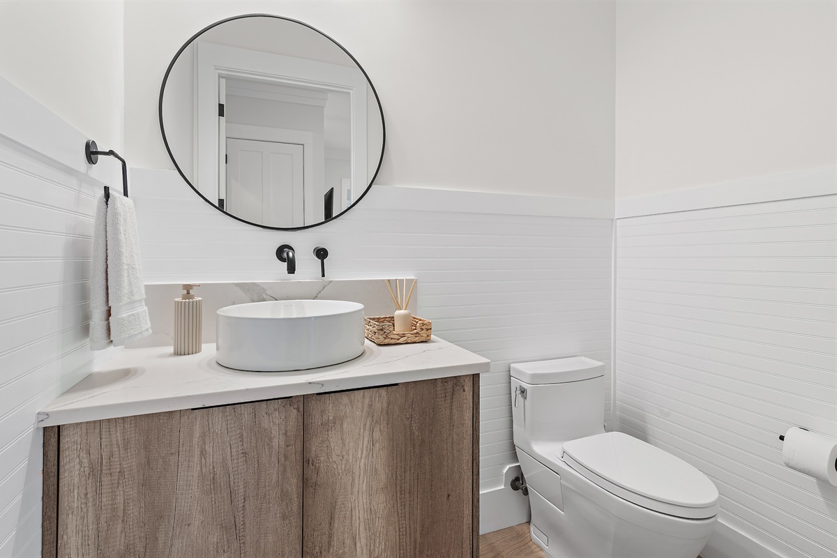 1st Floor Powder bath serves the living and dining areas of the home, as well as the pool area.