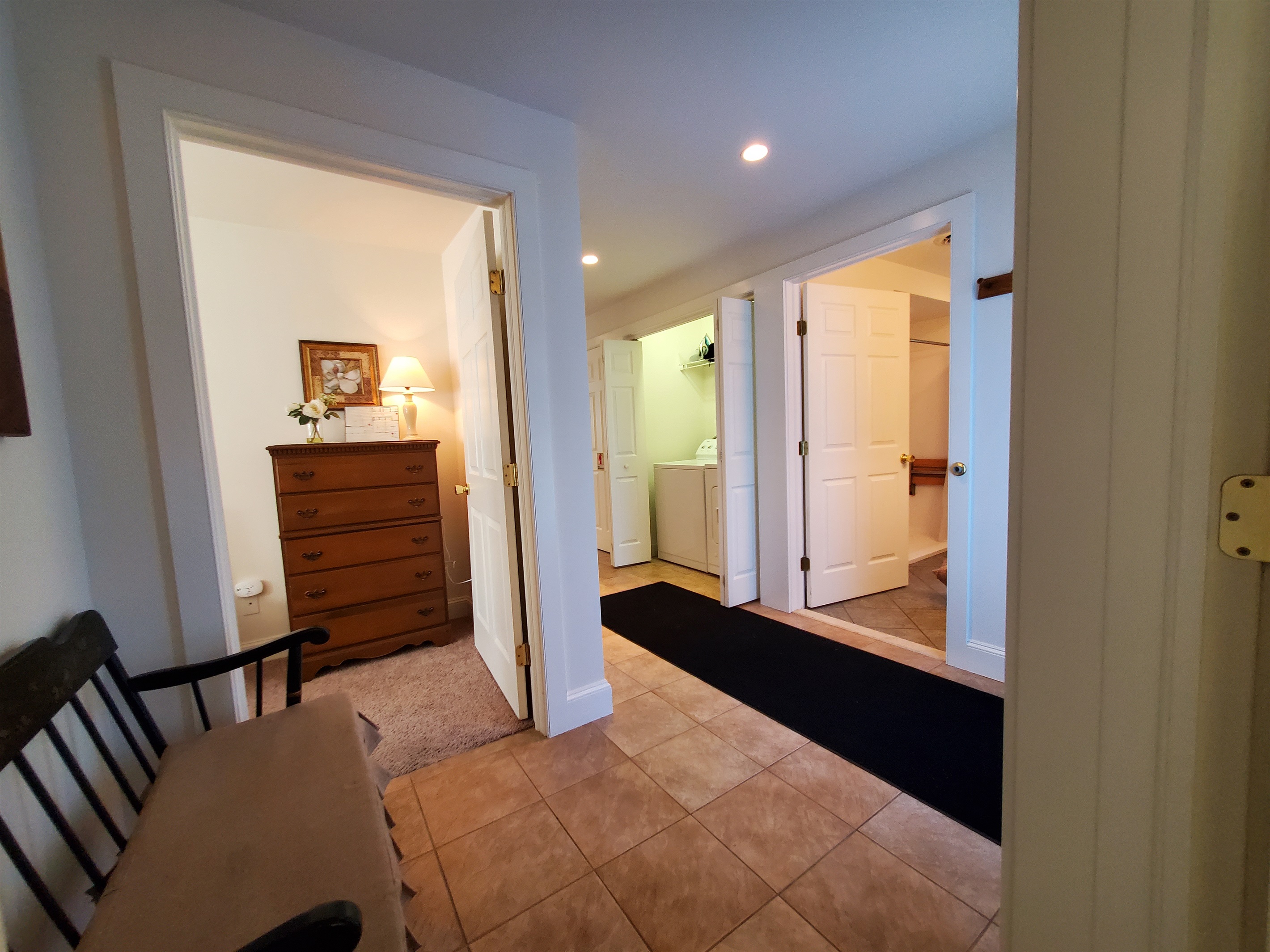View of main hallway and the entrance into the handicap accessible bathroom and the laundry area.