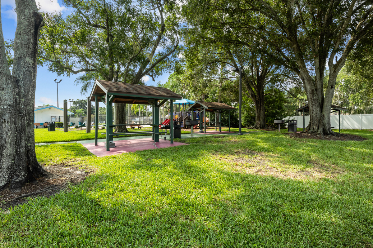 The recreation area includes a charcoal grill and table seating.