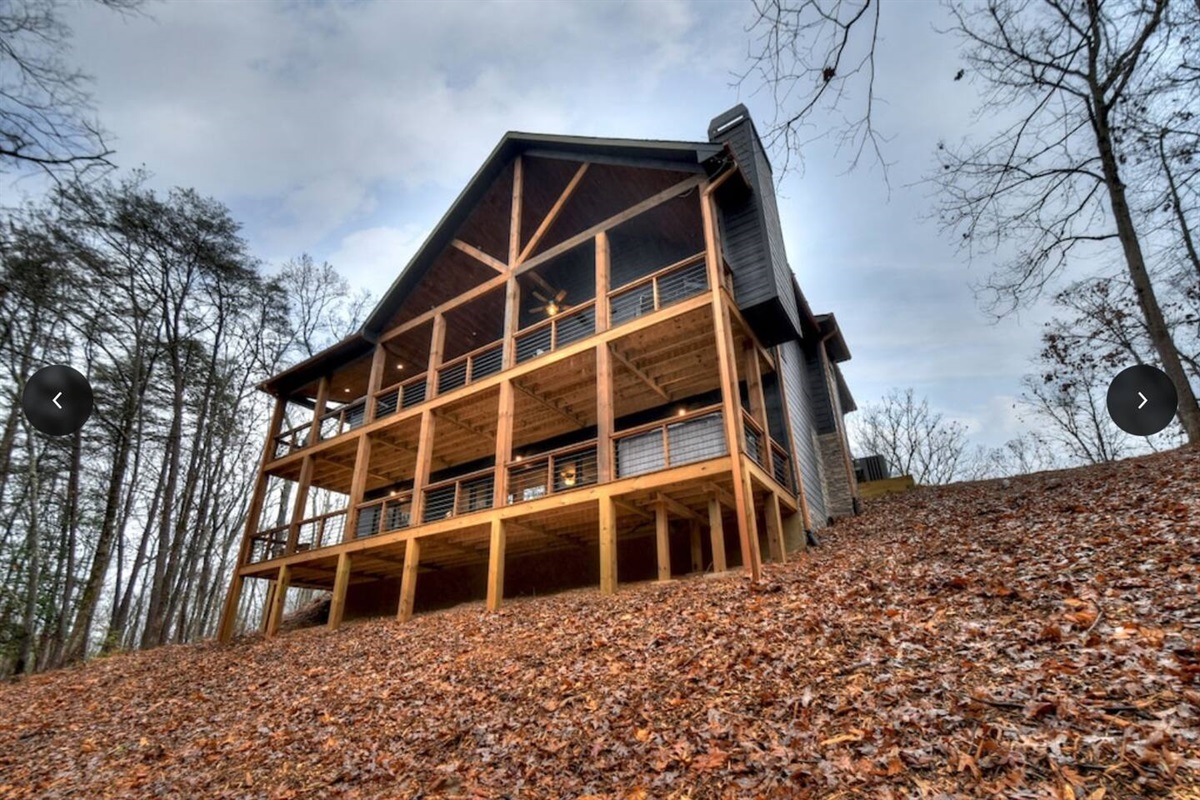 An uphill rear view of cabin from the woods