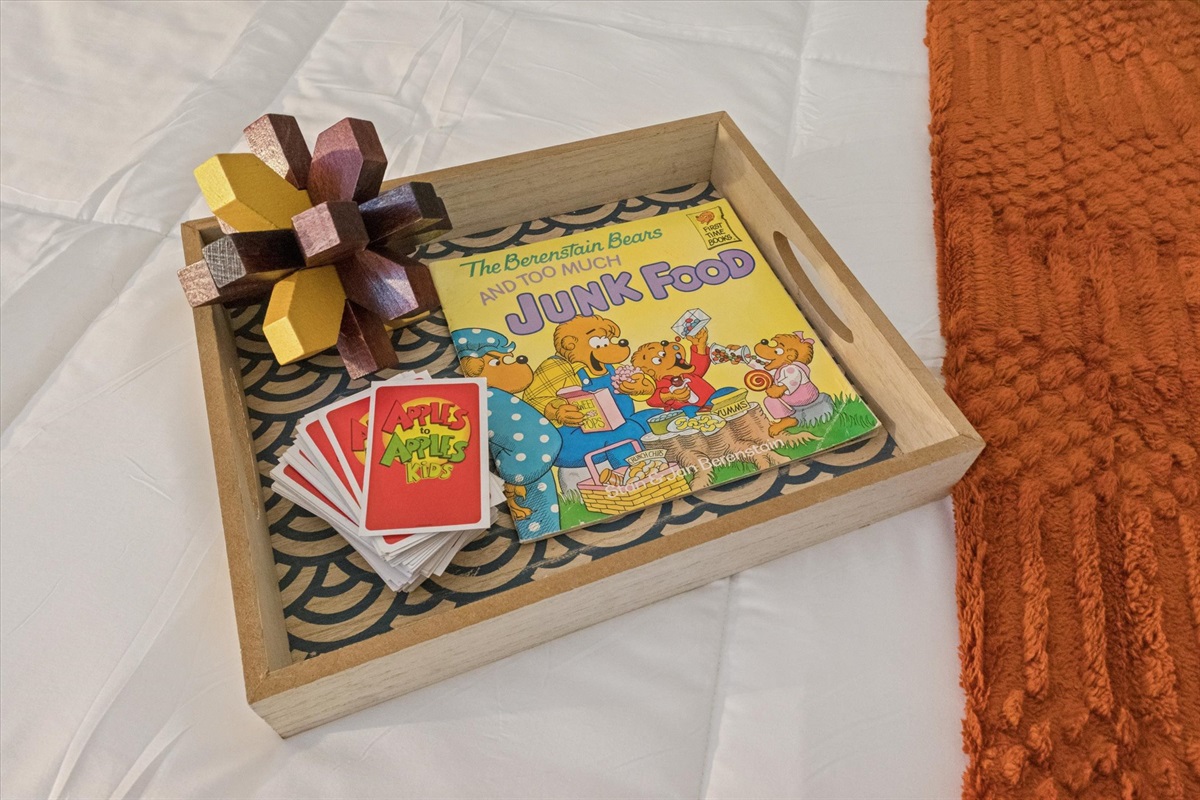 Games and toys rotate, but our South Bend guest retreat is always stocked with options for all ages—as shown here on the twin bed tray. Family fun and cozy moments await near Notre Dame.