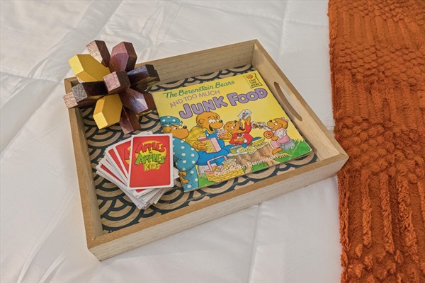 Games and toys rotate, but our South Bend guest retreat is always stocked with options for all ages—as shown here on the twin bed tray. Family fun and cozy moments await near Notre Dame.