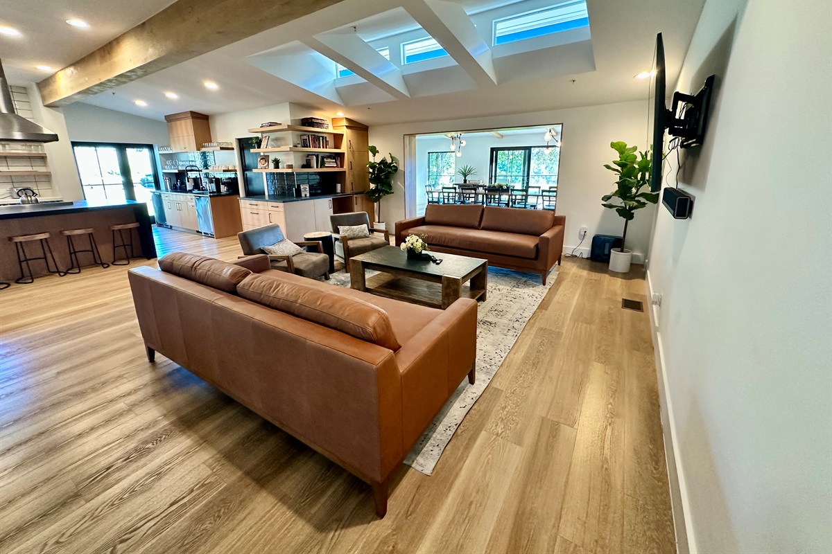 An open living area that connects the kitchen, lounge, and dining space.