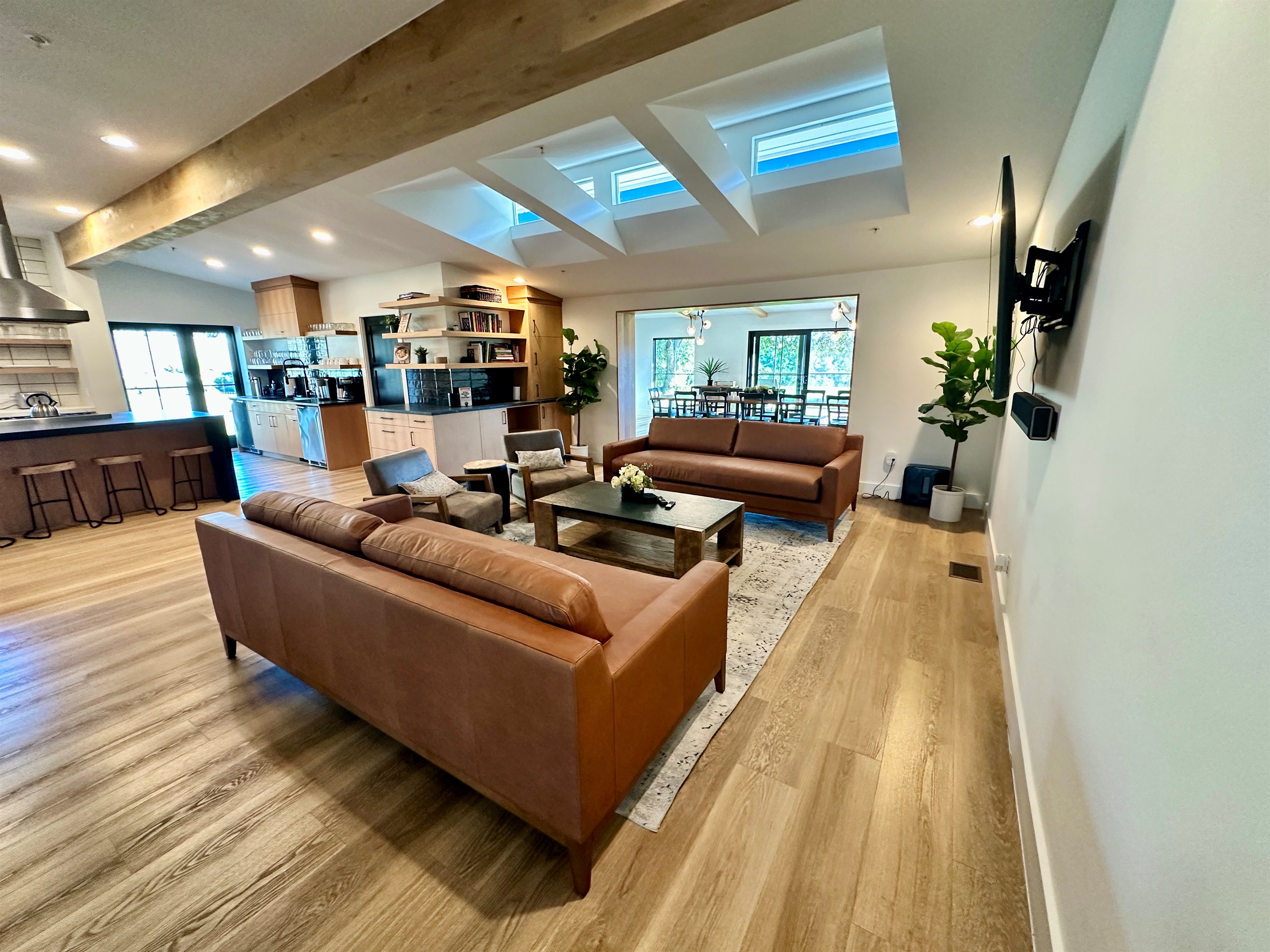 An open living area that connects the kitchen, lounge, and dining space.