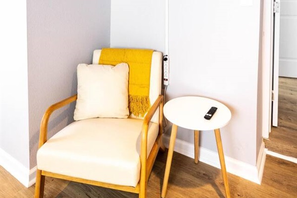 A cozy corner in the twin bedroom with a comfy chair and small table offers a peaceful spot to relax.