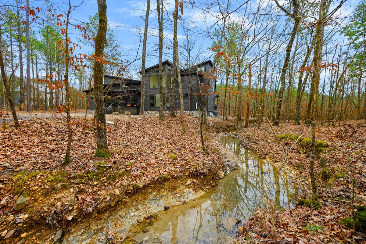A shallow creek winds through the property, adding calming sounds and a touch of nature to your stay.