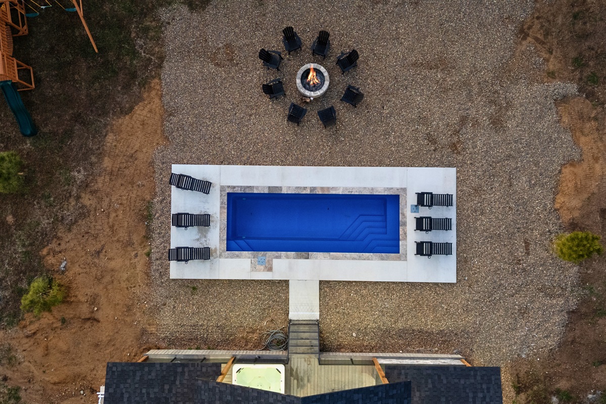 From above, the backyard layout becomes even clearer, showcasing the pool, fire pit, and open gathering spaces all in one view.