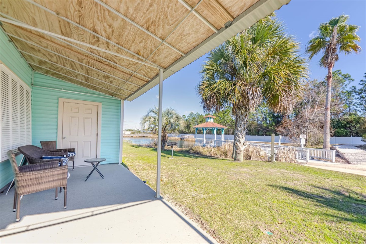 Patio Retreat: Unwind in stylish seating with serene views of palm trees and water. Perfect bliss!
