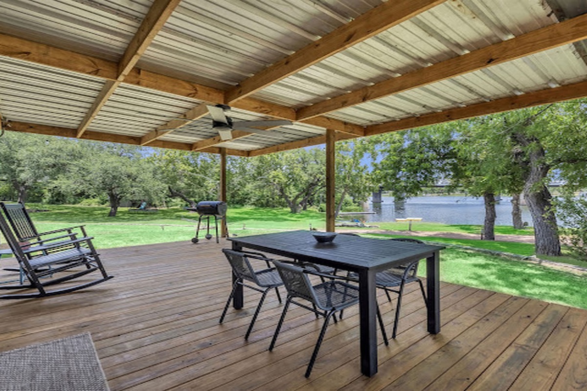 Spacious covered deck for outdoor dining and relaxing river views.