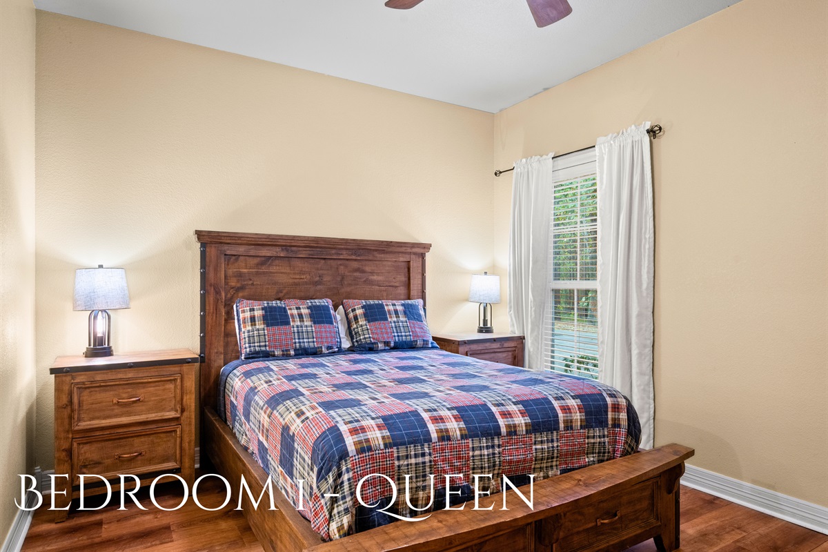 Bedroom 1 with queen bed and soft lighting.