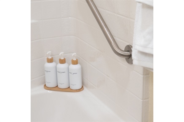 Shower with grab bars and provided shampoo, conditioner, and soap