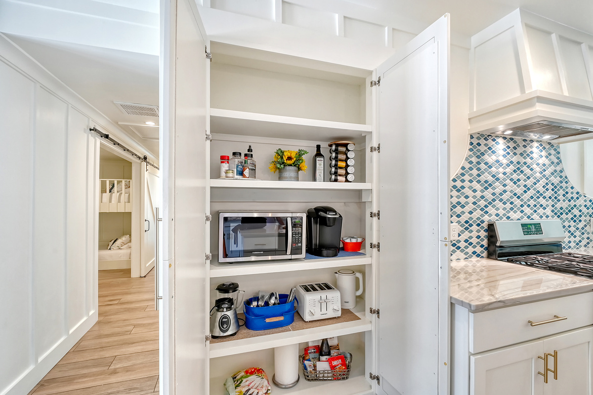 Kitchen pantry closet is stocked with spices and more