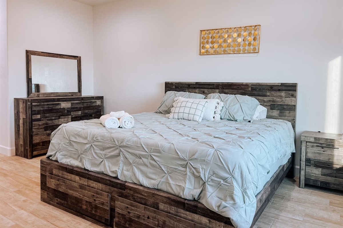 Bright and spacious master bedroom with king size bed 