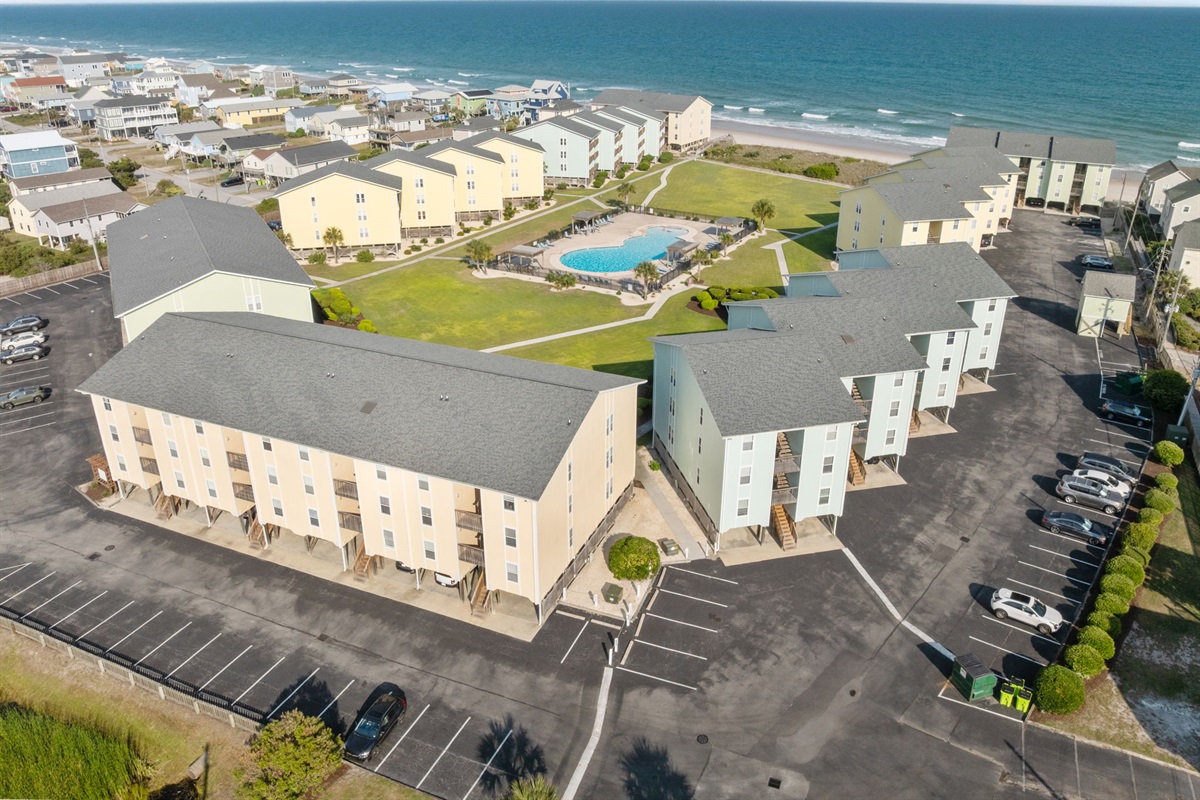 Expansive community layout featuring green space, pool, and ocean views