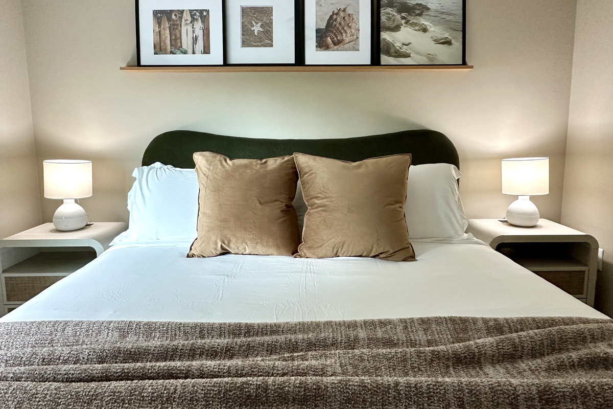 Layered bedding and soft lighting — every bedroom here is dressed for a real night's sleep.