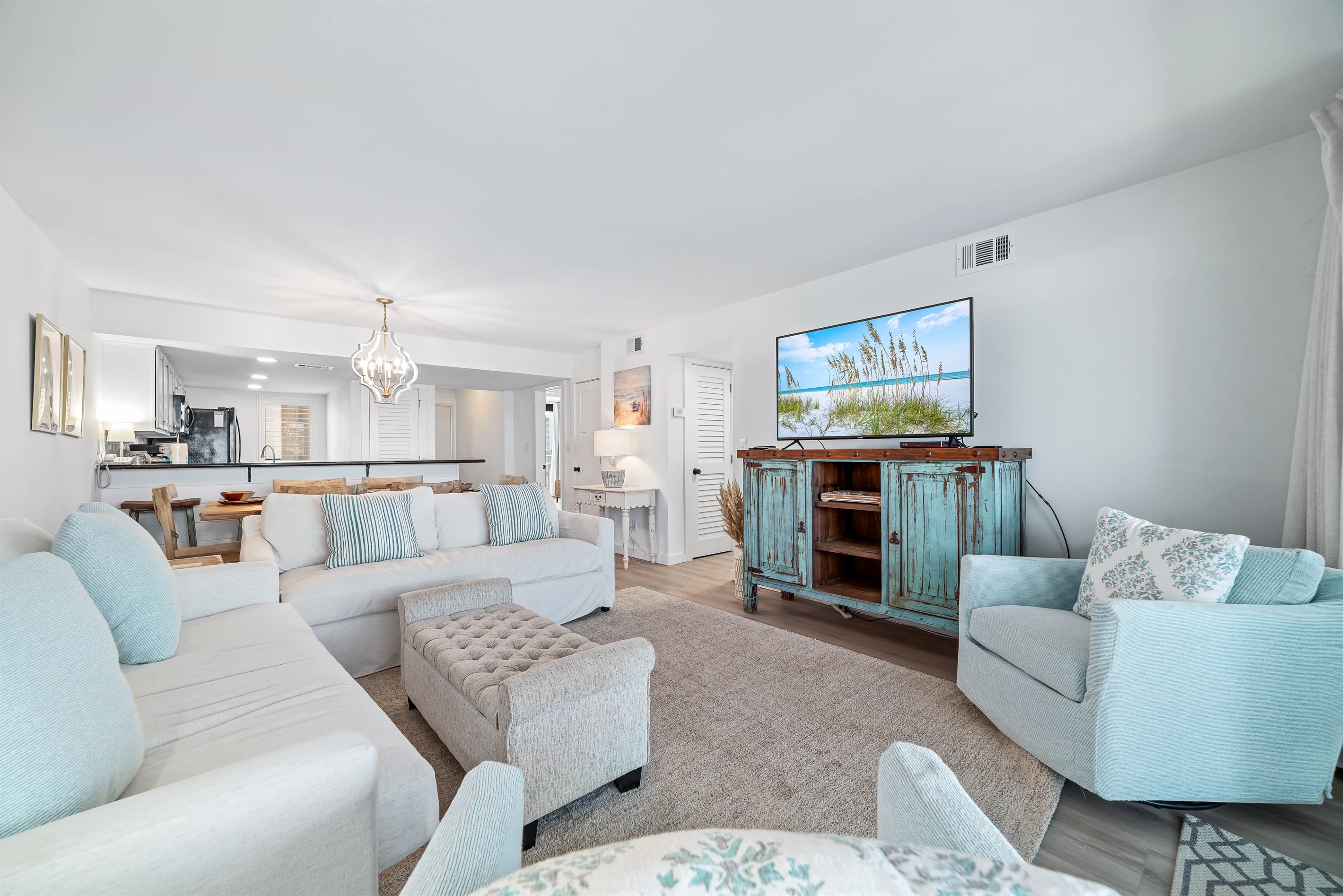 Experience the epitome of coastal living in this beautifully designed living room. Featuring plush furnishings, a serene color palette, and magnificent water views, this space offers a tranquil retreat for residents and guests alike.