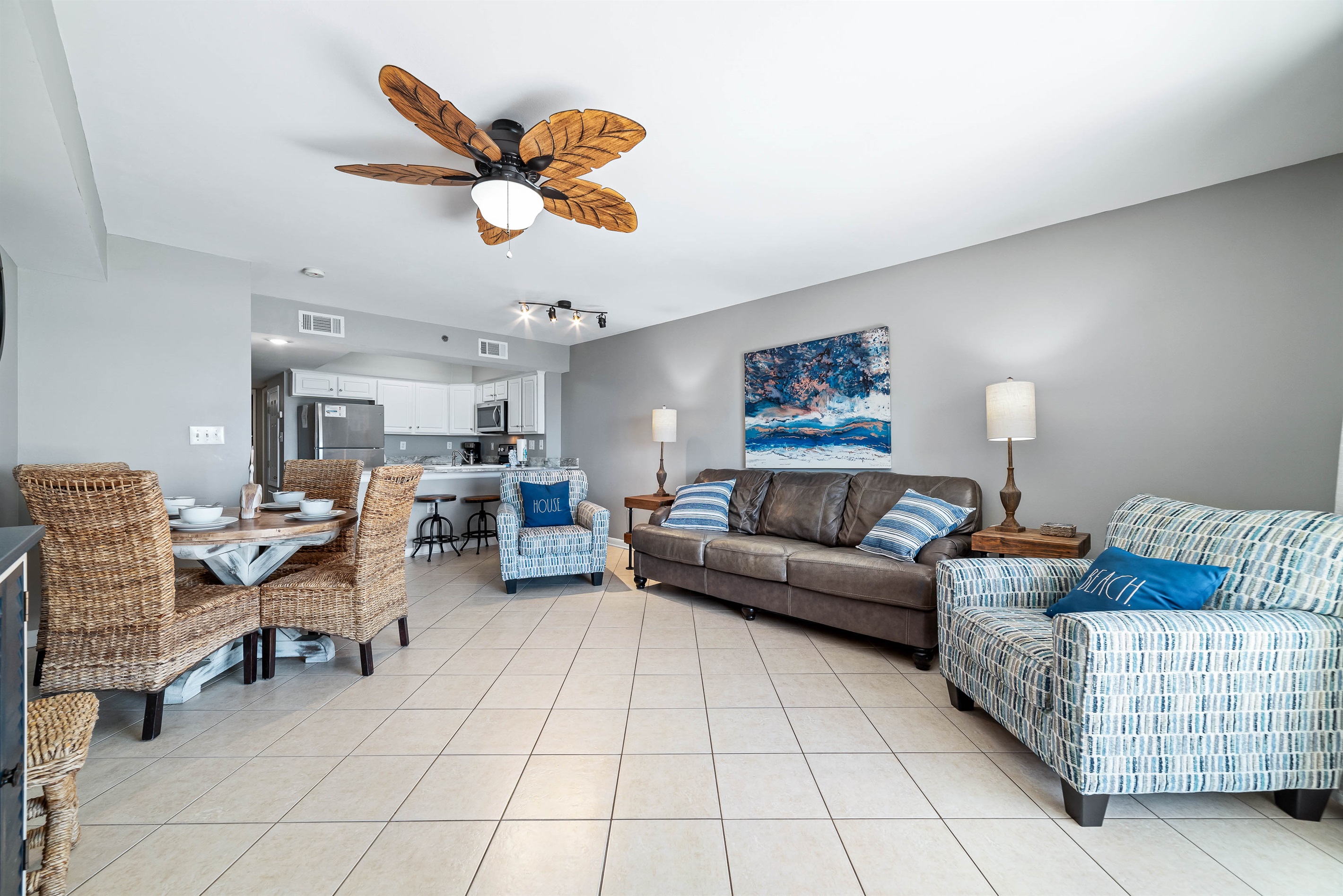 A comfortable living room with ample seating, flowing into a dining area, ideal for everyday living and gatherings.