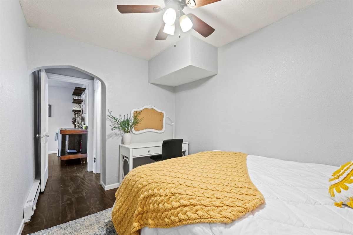 Cozy bedroom featuring a desk and chair, perfect for work or study in a comfortable and functional space.