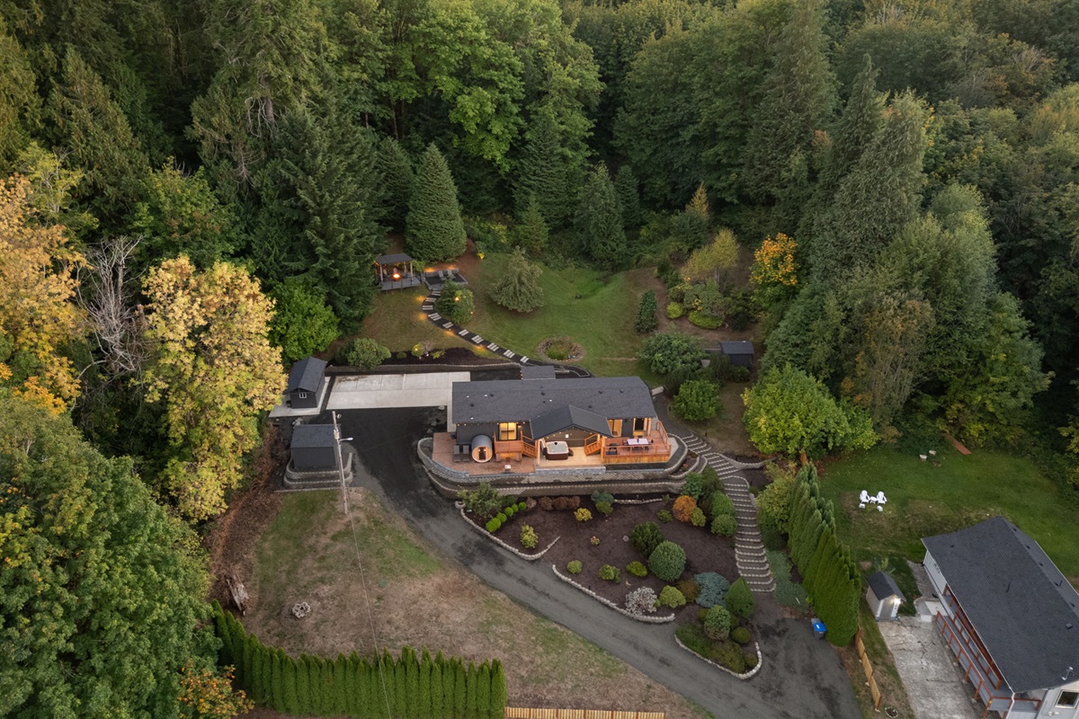 Aerial twilight view showcasing the home’s warm light and vast, serene surroundings