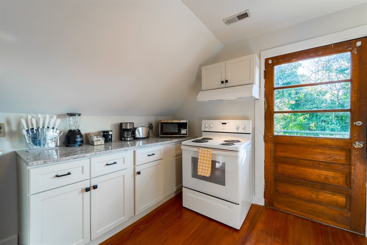 Newly renovated kitchen offers the comforts of home. Original wood door leads to a private deck off of the kitchen.