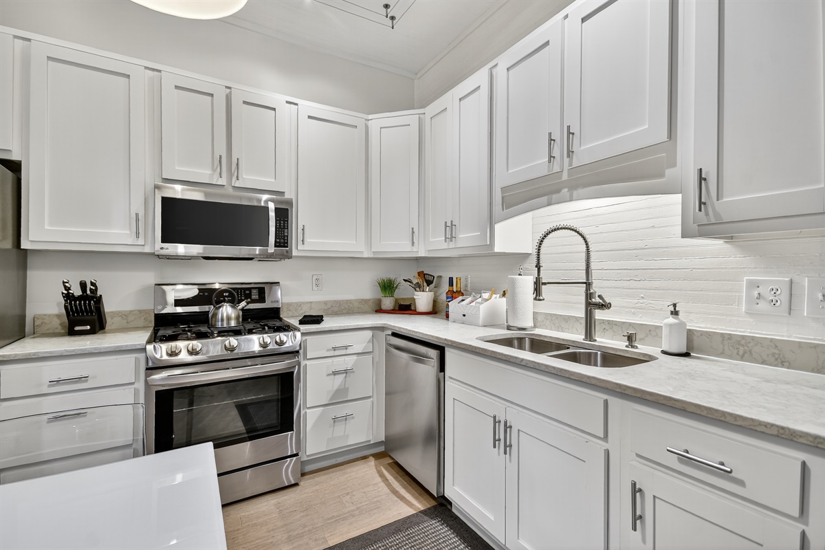 This modern kitchen features a gas stove, full cookware, sleek finishes, and a stocked coffee bar&mdash;perfect for slow mornings before exploring downtown Blue Ridge.  
